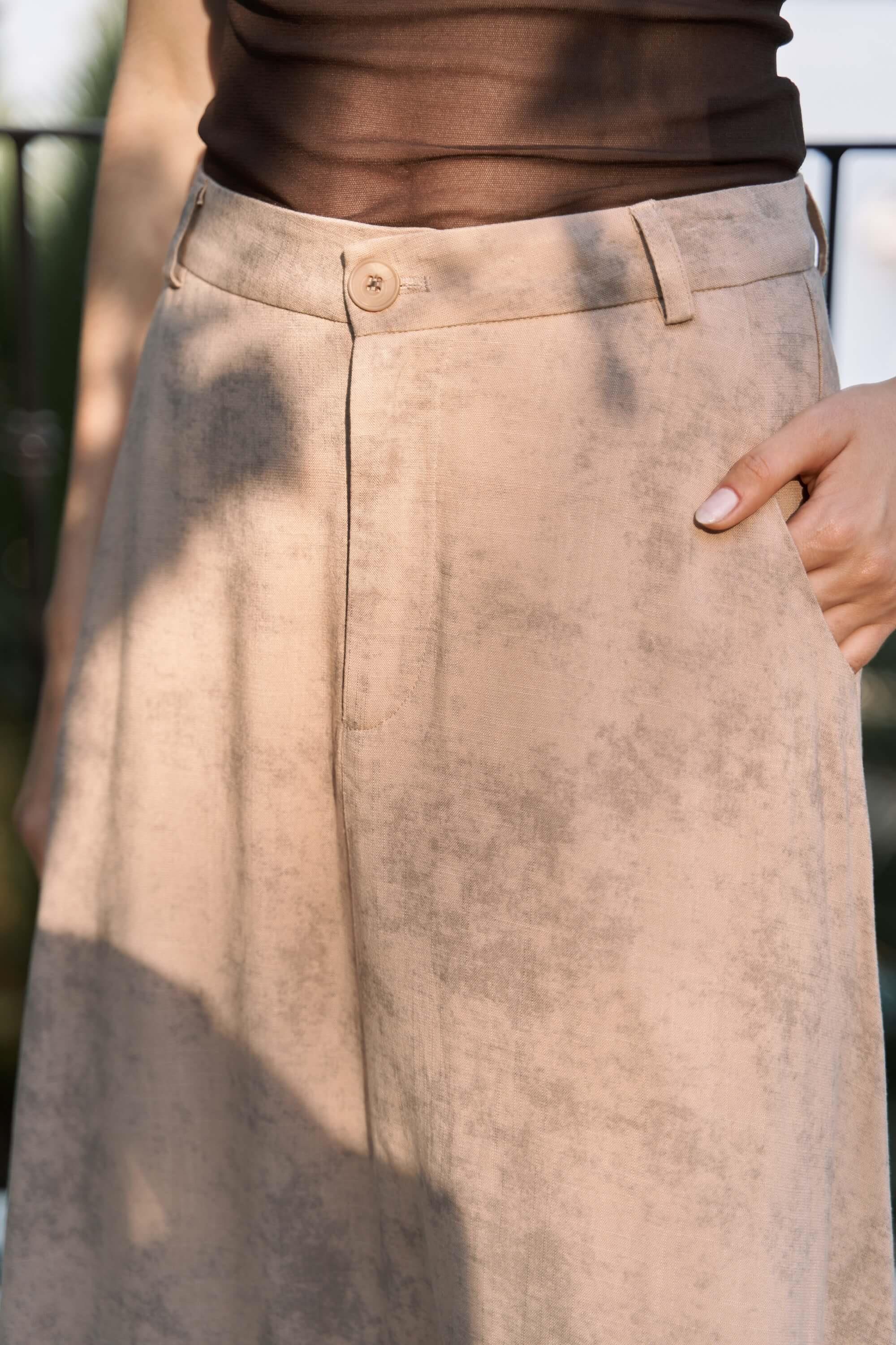 Close-up of a beige cotton batik maxi skirt with a blurred background