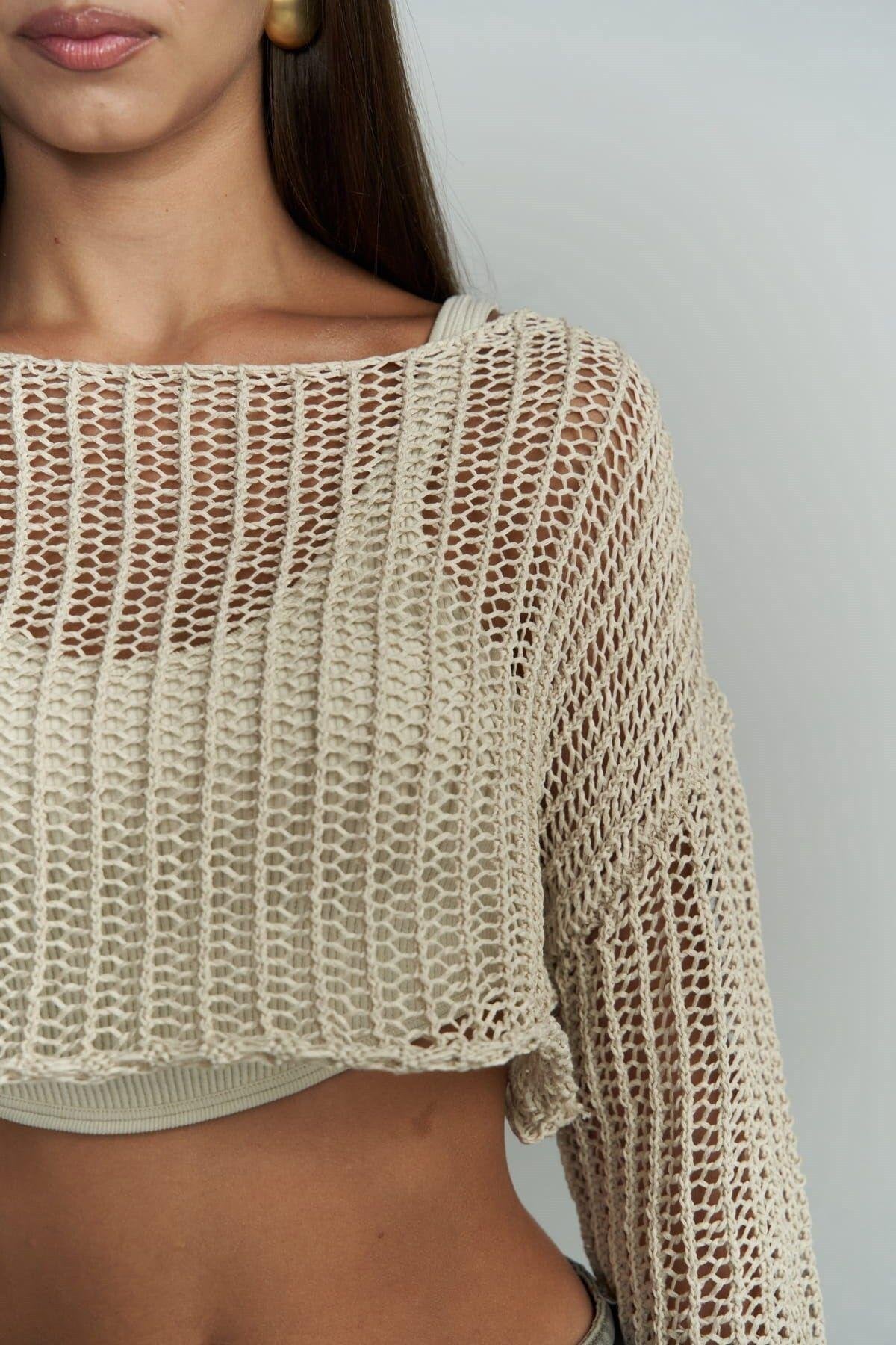 Lightweight crochet sweater layered over ribbed tank