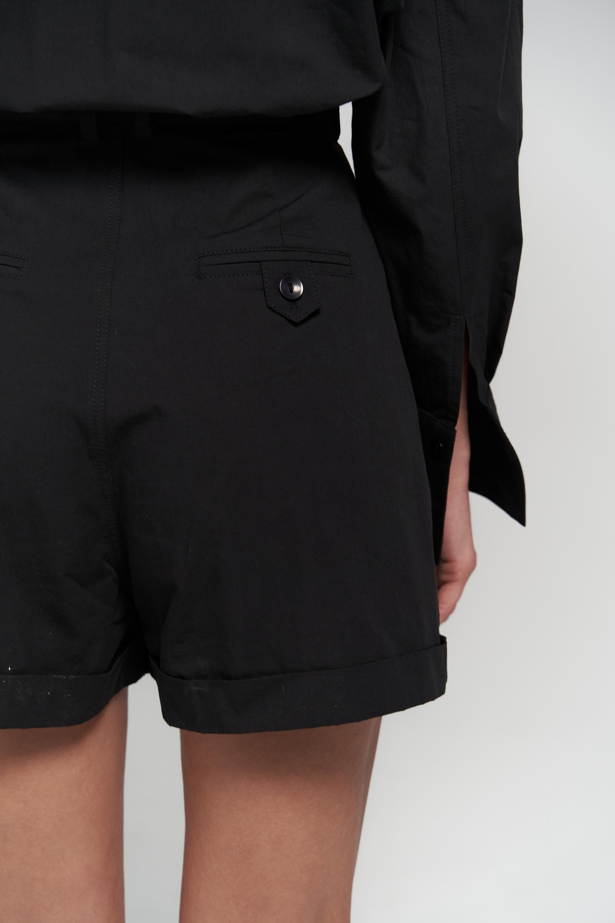 SHAÉN belted black romper from behind angle