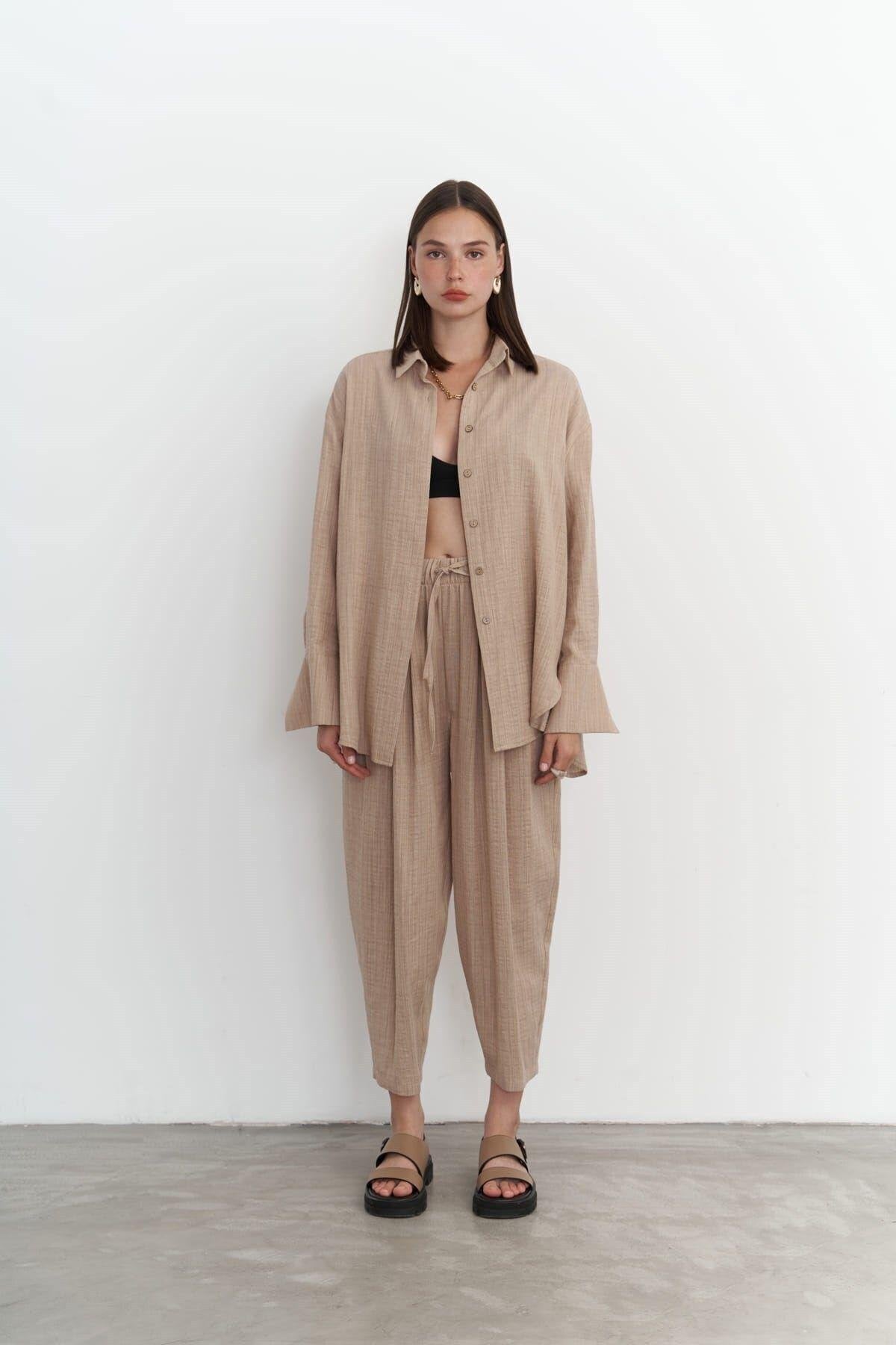 Woman in oversized cotton-linen shirt and tapered pants